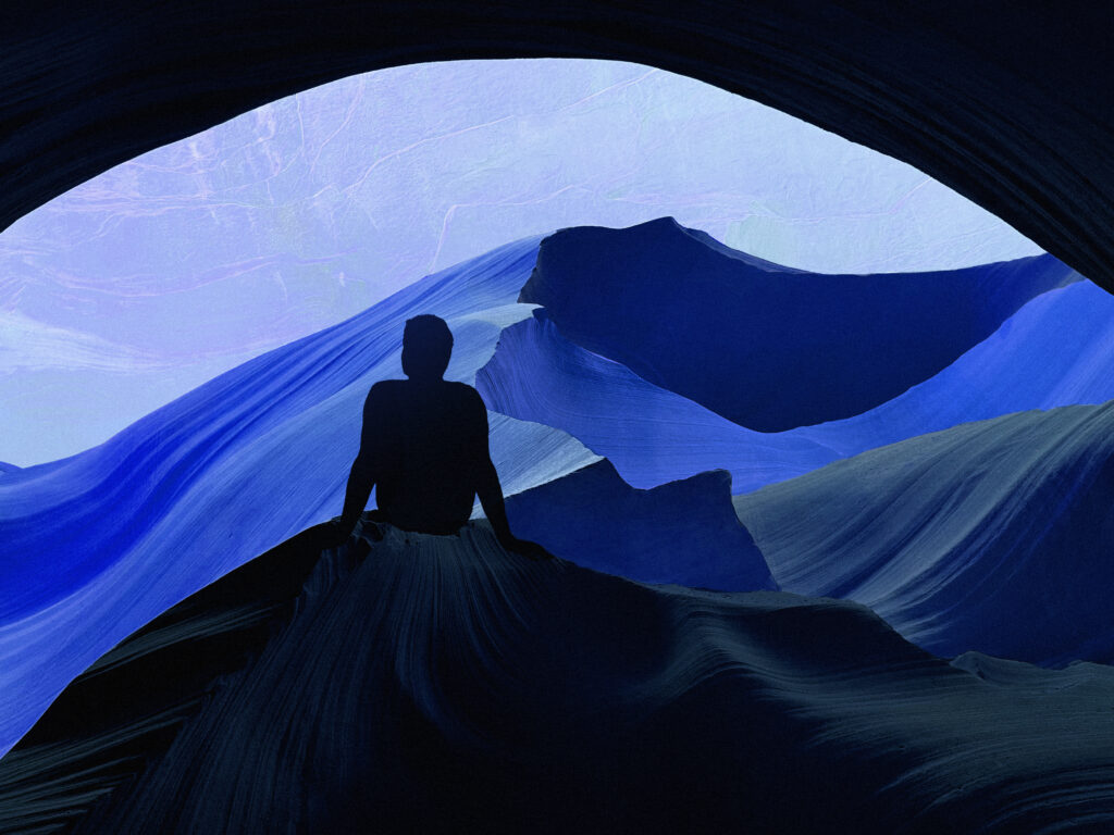 Silhouette with anxiety gazes from cave over abstract blue mountains.